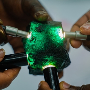 hands-shining-flash-on-emerald