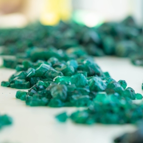 piles-of-emeralds-on-white-surface